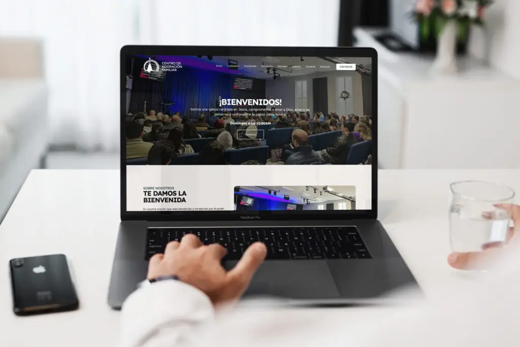Centro de Adoracion Familiar Spanish church website shown on laptop and phone